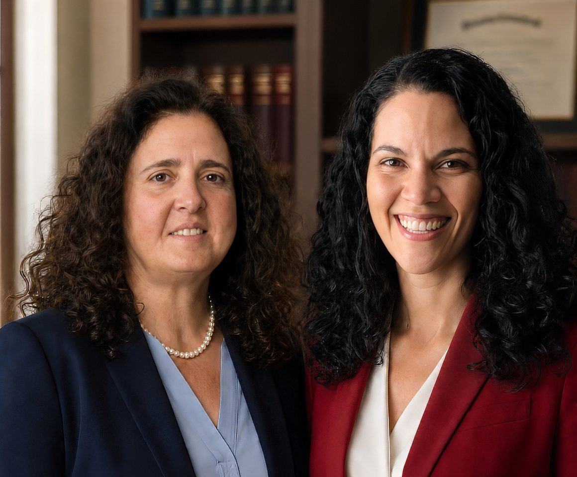 The two founding attorneys of Delgado Purdy Law standing together in the firm's office